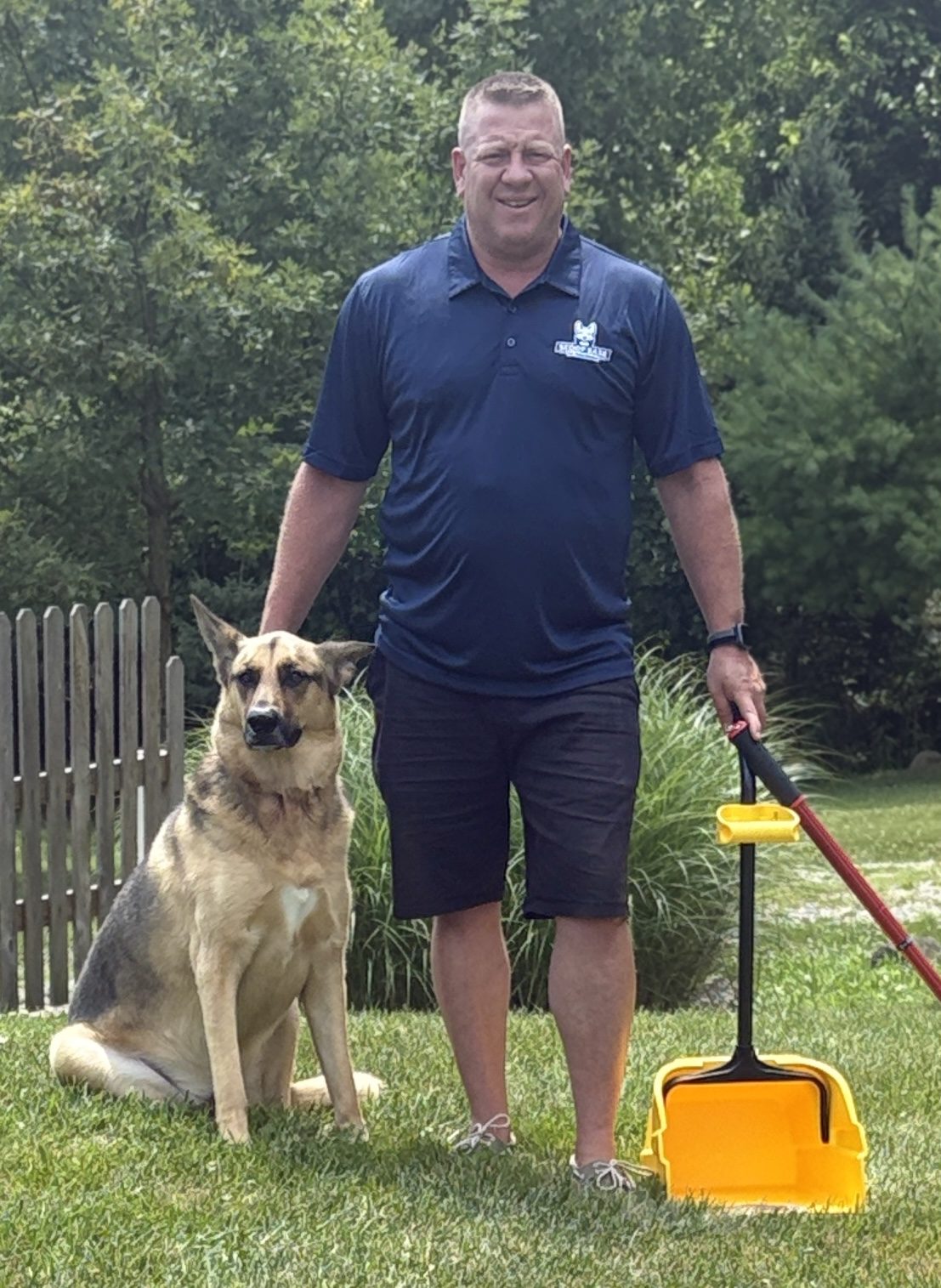 Ned McIlwain, owner of Scoop Ease, with his dog Wesley